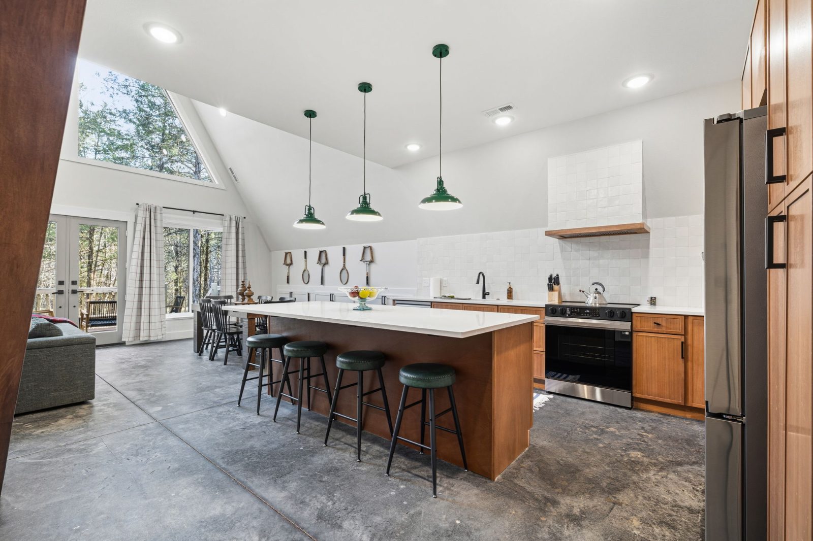 The open kitchen and dining area under the soaring A-frame ceiling