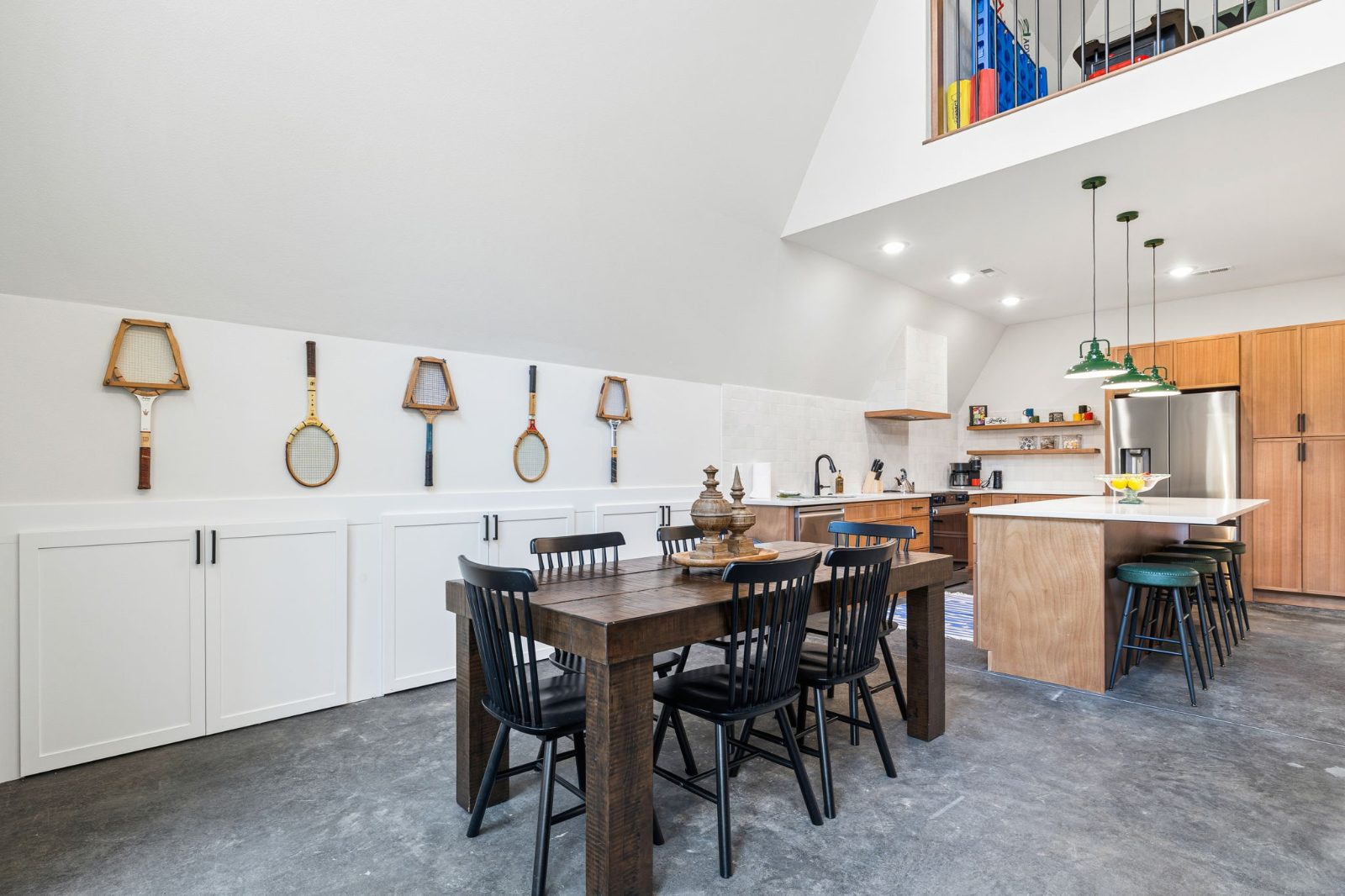 Dining room with vintage tennis rackets on the wall, seating for 6