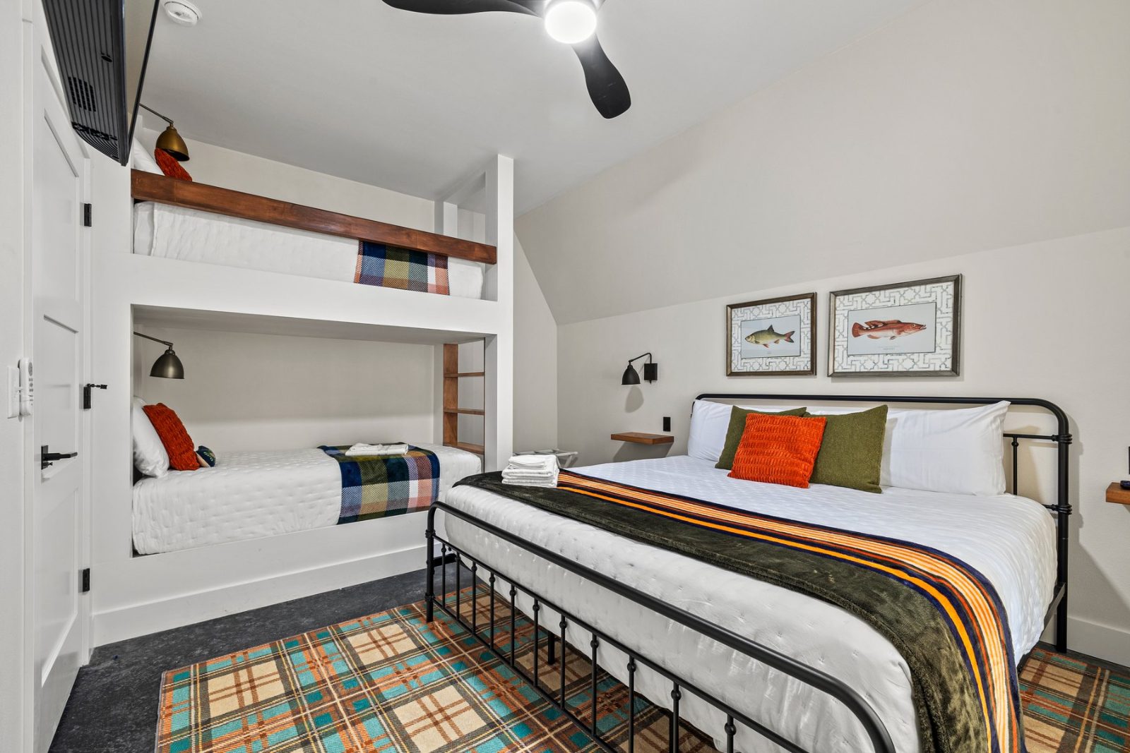 Bunk room — built-in bunk beds plus a king bed under the A-frame ceiling