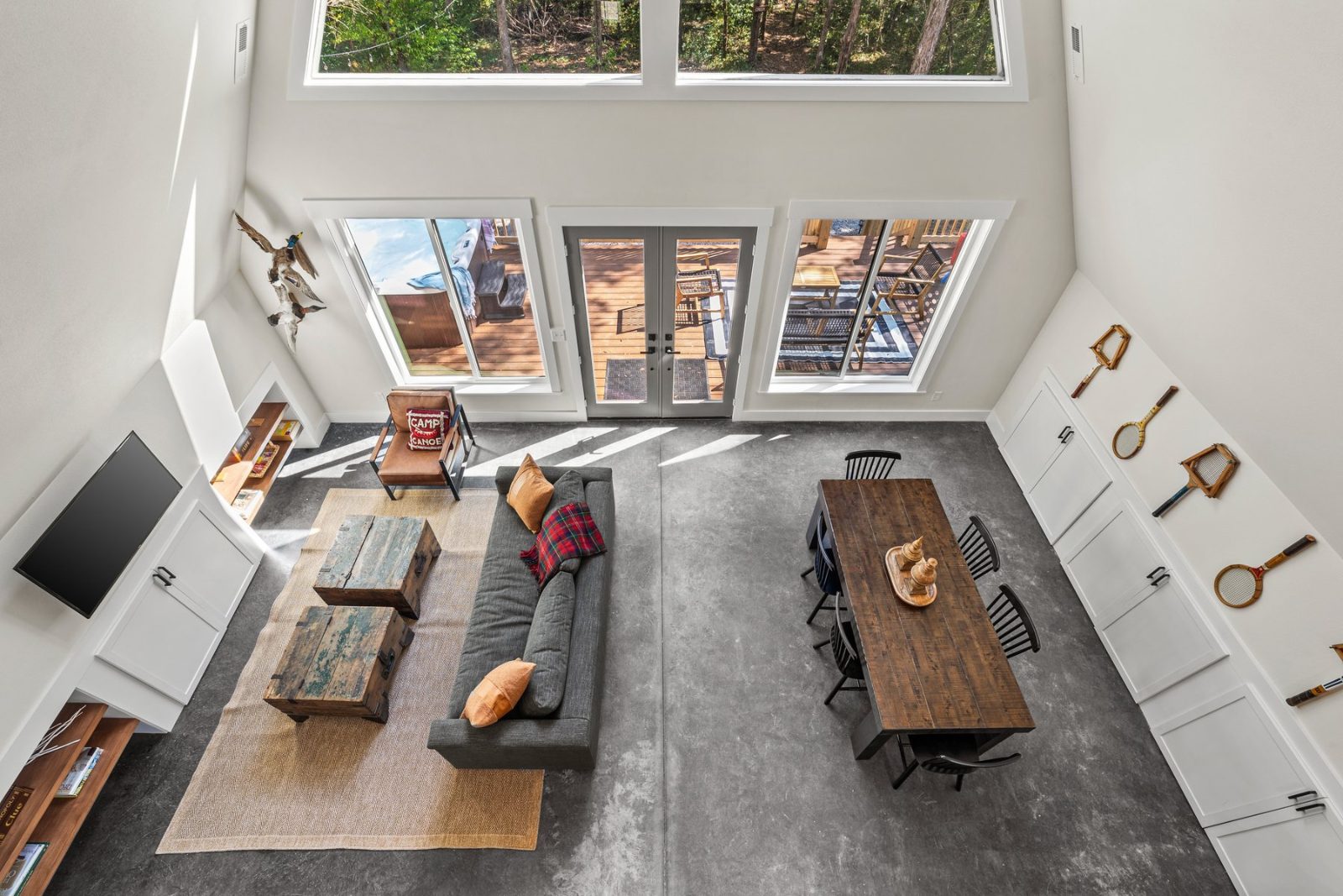 Bird's-eye view from the loft showing the full living + dining floor plan